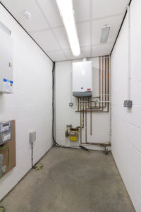 An Industrial Unit in Grimsby's Enterprise Village, consisting of a small room with a water heater and pipes.