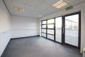An empty Grimsby office with a glass door.