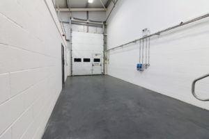 An Industrial Unit in Enterprise Village, Grimsby hosting a hallway with stairs and a door.