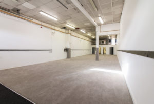 A large empty industrial unit with white walls and carpet located at 352 Pelham Road in Immingham.