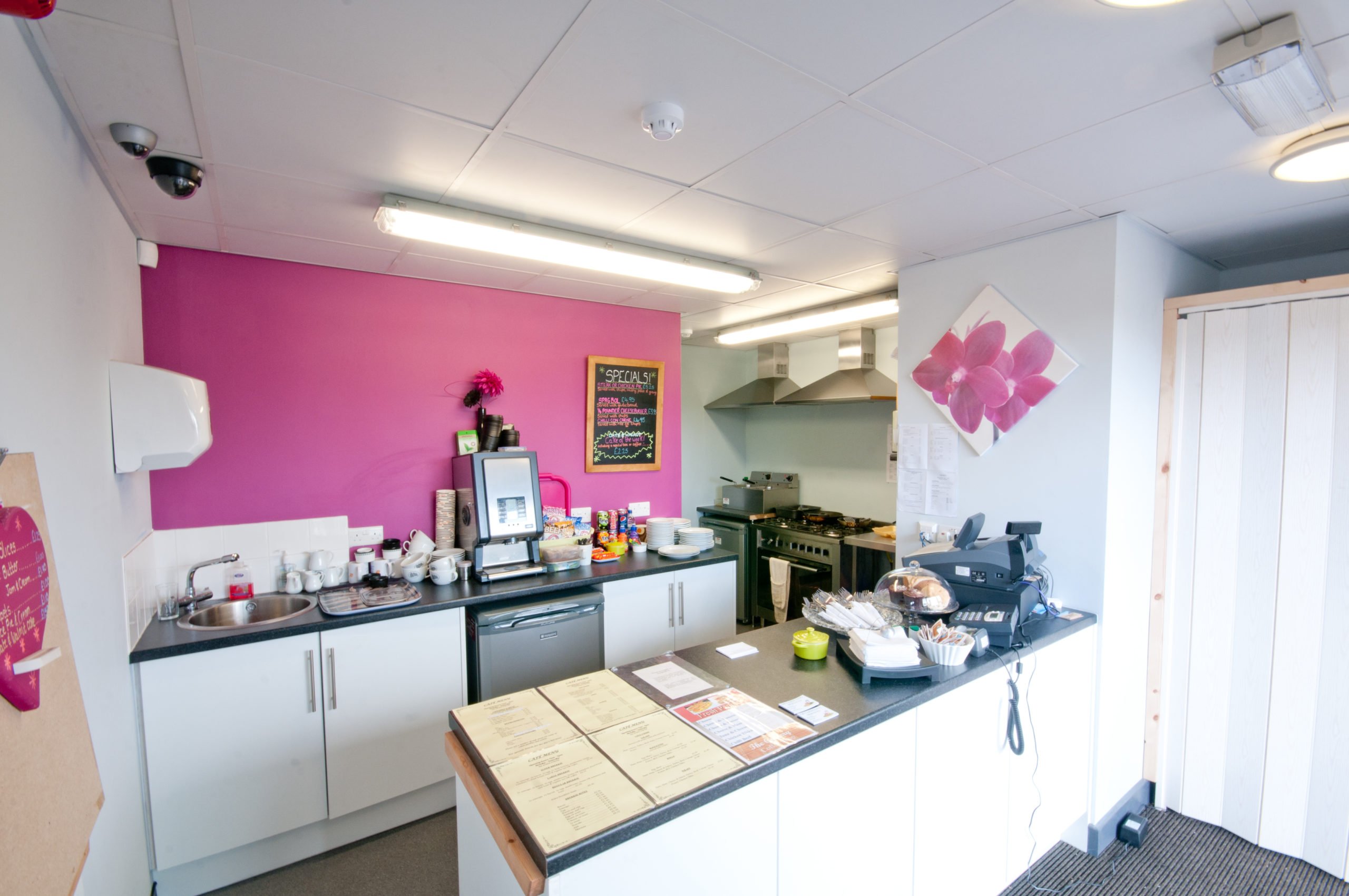 A café with a pink wall.