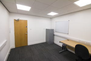An Office located at 9 Business Hive in Grimsby, with a desk and a whiteboard.