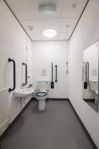 An industrial unit located in Grimsby's Enterprise Village, featuring a bathroom equipped with a toilet, sink and mirror.
