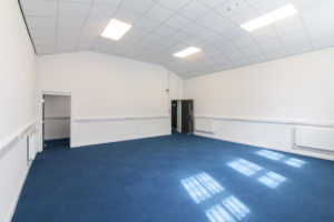 An office with blue carpet and white walls located at 84 Wellington Street, Grimsby in the Enterprise Suite.
