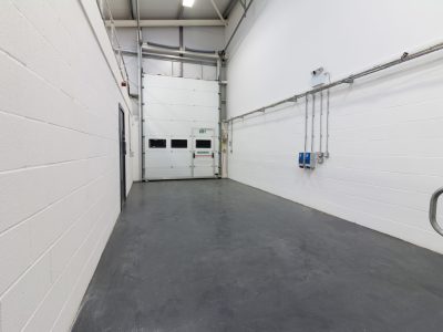 An Industrial Unit in Enterprise Village, Grimsby hosting a hallway with stairs and a door.