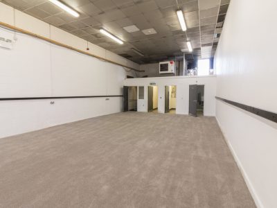 Industrial Unit with white walls and carpet.